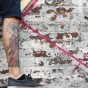tattoo leg standing on ledge of wall during mural painting